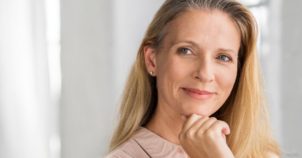 Mature woman with hand gently on her chin (MODEL)